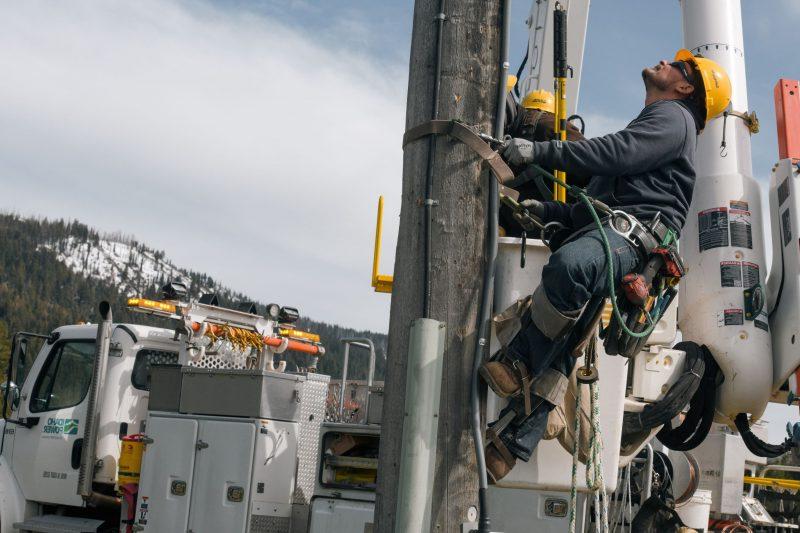 Image of a lineman apprentice climbing a power pole.